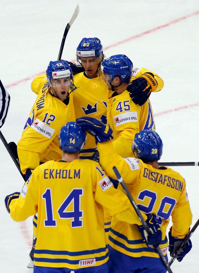 Sweden's Mikael Backlund (top) celebrates his goal against Denmark with team mates during the first period of their men's ice hockey World Championship group A game at Ch