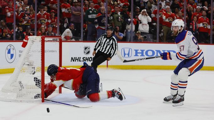 Jun 18, 2024; Sunrise, Florida, USA; Florida Panthers forward Matthew Tkachuk (19) reaches for the puck on an empty net attempt on goal by Edmonton Oilers forward Connor