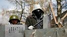 Pro-Russian protesters stand at barricades at the police headquarters in Slaviansk, April 15, 2014.