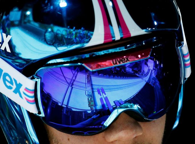 The ski jump is seen in Greece's Polychronidis' goggles as he prepares to jump during the men's ski jumping individual normal hill training event of the Sochi 2014 Winter