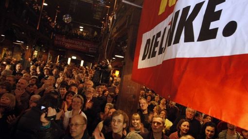 Members of the German socialist Die Linke party react as they watch first poll results in the German federal state of Hamburg February 24, 2008. German Chancellor Angela Merkel's conservatives appeared on track to retain power in an election in the northern city-state of Hamburg on Sunday which also delivered gains for a new far-left party. REUTERS/Johannes Eisele (GERMANY)