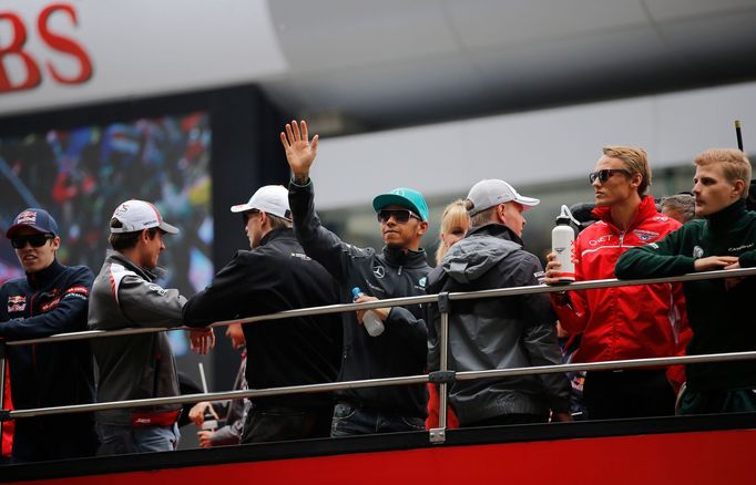 Mercedes Formula One driver Lewis Hamilton of Britain waves from a bus during the drivers' parade before the Chinese F1 Grand Prix at the Shanghai International circuit,