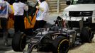 The car of Sauber Formula One driver Esteban Gutierrez of Mexico is removed from the track during the Bahrain F1 Grand Prix at the Bahrain International Circuit (BIC) in