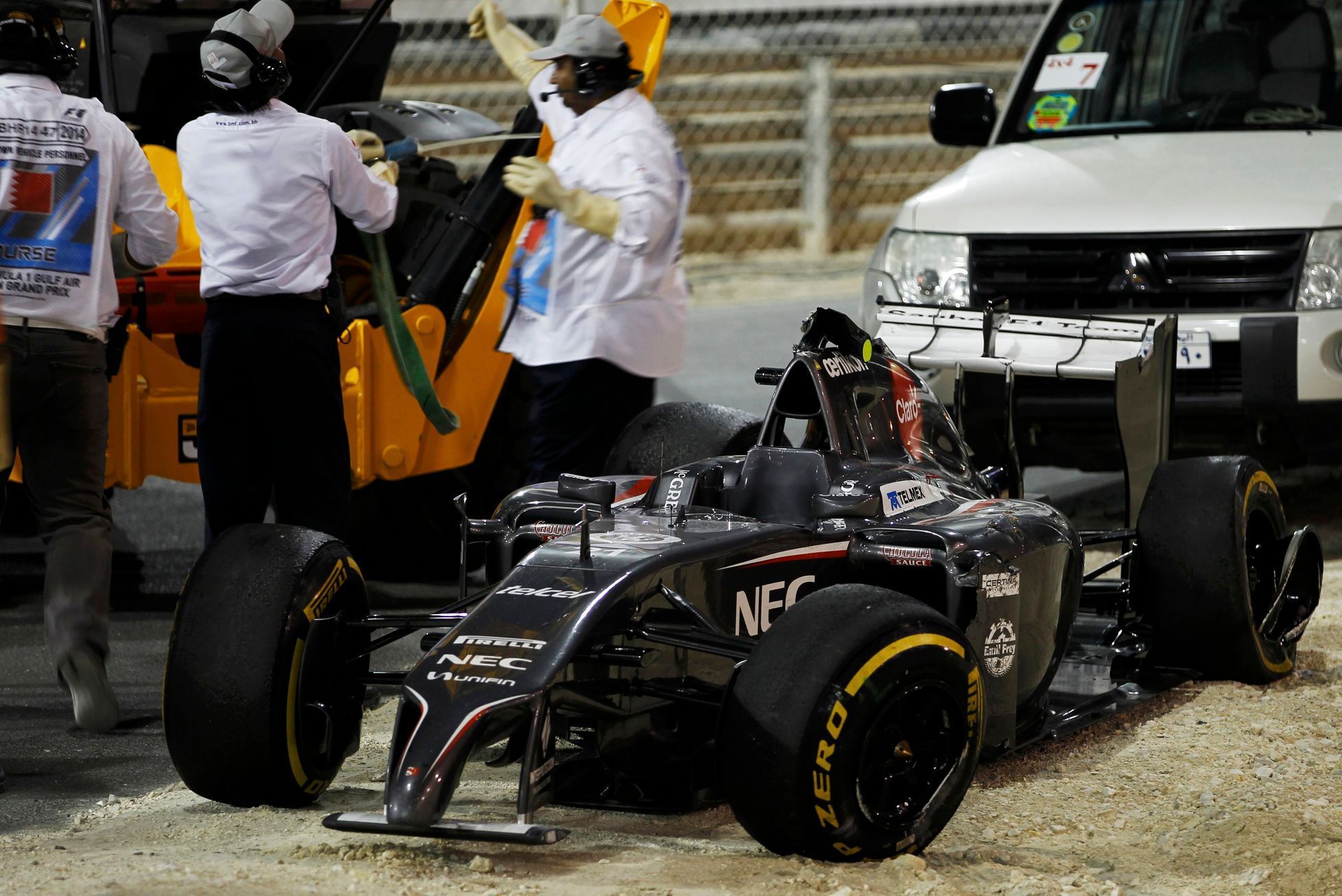 The car of Sauber Formula One driver Esteban Gutierrez of Mexico is removed from the track during the Bahrain F1 Grand Prix at the Bahrain International Circuit (BIC) in Sakhir
