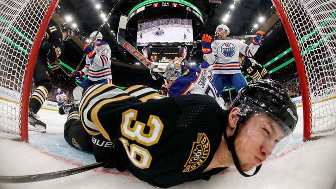 Mar 5, 2024; Boston, Massachusetts, USA; Boston Bruins center Morgan Geekie (39) is dumped into the Edmonton Oilers net during the second period at TD Garden. Mandatory C