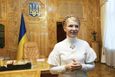 Yulia Tymoshenko smiles inside her cabinet on her second term's first working day as Ukrainian Prime Minister in Kiev in this December 19, 2007 handout photo. International pressure mounted on Ukraine on Thursday over its treatment of jailed opposition leader Yulia Tymoshenko, but Kiev warned that any boycott of the European soccer championship next month would only hurt the interests of football fans. Photo taken December 19, 2007. REUTERS/Alexander Prokopenko/Yulia Tymoshenko Press Service/Handout (UKRAINE - Tags: POLITICS CRIME LAW) FOR EDITORIAL USE ONLY. NOT FOR SALE FOR MARKETING OR ADVERTISING CAMPAIGNS