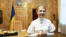 Yulia Tymoshenko smiles inside her cabinet on her second term's first working day as Ukrainian Prime Minister in Kiev in this December 19, 2007 handout photo. International pressure mounted on Ukraine on Thursday over its treatment of jailed opposition leader Yulia Tymoshenko, but Kiev warned that any boycott of the European soccer championship next month would only hurt the interests of football fans. Photo taken December 19, 2007. REUTERS/Alexander Prokopenko/Yulia Tymoshenko Press Service/Handout (UKRAINE - Tags: POLITICS CRIME LAW) FOR EDITORIAL USE ONLY. NOT FOR SALE FOR MARKETING OR ADVERTISING CAMPAIGNS