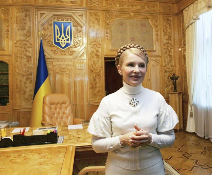 Yulia Tymoshenko smiles inside her cabinet on her second term's first working day as Ukrainian Prime Minister in Kiev in this December 19, 2007 handout photo. International pressure mounted on Ukraine on Thursday over its treatment of jailed opposition leader Yulia Tymoshenko, but Kiev warned that any boycott of the European soccer championship next month would only hurt the interests of football fans. Photo taken December 19, 2007. REUTERS/Alexander Prokopenko/Yulia Tymoshenko Press Service/Handout (UKRAINE - Tags: POLITICS CRIME LAW) FOR EDITORIAL USE ONLY. NOT FOR SALE FOR MARKETING OR ADVERTISING CAMPAIGNS