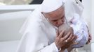 Pope Francis kisses a baby at the end of a canonization mass in Saint Peter's Square at the Vatican May 12, 2013. The Pope led a mass on Sunday for candidates for sainthood Antonio Primaldo, Mother Laura Montoya and Maria Guadalupe Garcia Zavala.