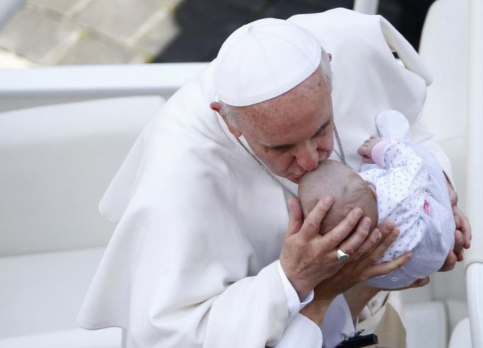 Pope Francis kisses a baby at the end of a canonization mass in Saint Peter's Square at the Vatican May 12, 2013. The Pope led a mass on Sunday for candidates for sainthood Antonio Primaldo, Mother Laura Montoya and Maria Guadalupe Garcia Zavala.