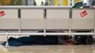 A man sleeps under a bench at Terminal 4 during a 24-hour nationwide general strike, at Madrid's Barajas airport November 14, 2012. Spanish and Portuguese workers are staging the first coordinated general strike across the Iberian Peninsula on Wednesday, shutting transport, grounding flights and closing schools to protest against spending cuts and tax hikes. REUTERS/Sergio Perez (SPAIN - Tags: POLITICS BUSINESS EMPLOYMENT CIVIL UNREST TRANSPORT) Published: Lis. 14, 2012, 9:09 dop.