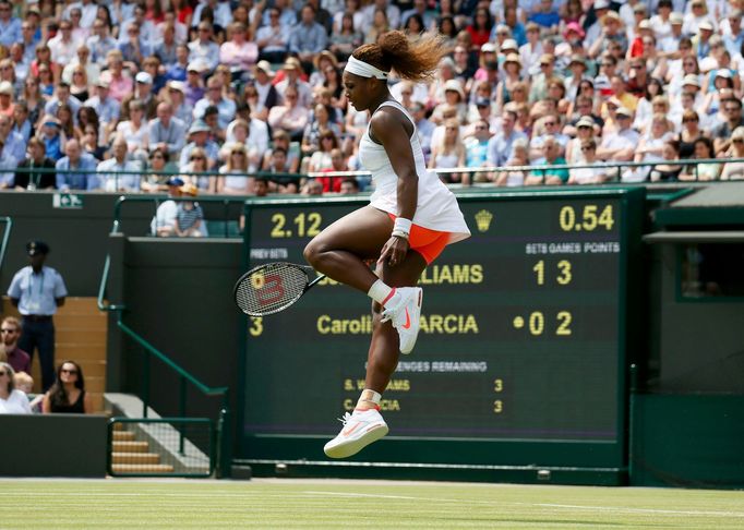 Serena Williams of the U.S. jumps as she reacts during her women's singles tennis match against Caroline Garcia of France at the Wimbledon Tennis Championships, in London