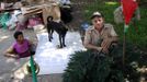 Miguel Restrepo, 62, and wife Maria Garcia (R) make Christmas ornaments outside their sewer home in Medellin December 4, 2012. The former drug addict has been living in an abandoned sewer with his wife and dog Blackie for 22 years. Their home, which is fitted with a kitchen, a fan, tv, a chair and a bed, is a 6 square meter wide and 1.4 meters high tunnel that leaks when it rains, and requires a manhole cover. REUTERS/Albeiro Lopera (COLOMBIA - Tags: SOCIETY POVERTY) Published: Pro. 4, 2012, 9:42 odp.