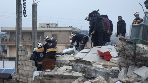 Rescuers work at the site of a damaged building, following an earthquake, in rebel-held Azaz, Syria