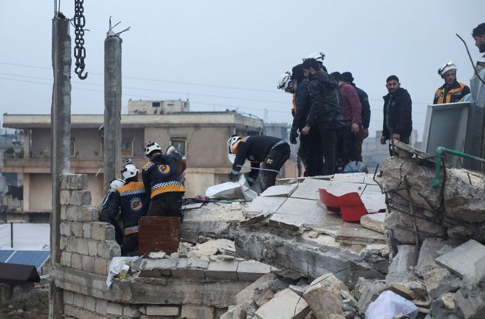 Rescuers work at the site of a damaged building, following an earthquake, in rebel-held Azaz, Syria