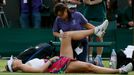 Maria Sharapova of Russia receives medical attention during her women's singles tennis match against Michelle Larcher De Brito of Portugal at the Wimbledon Tennis Champio