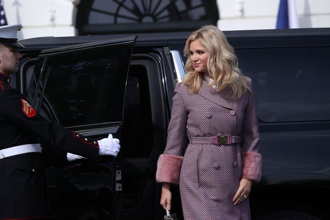 A U.S. Marine opens a door for Mrs. Monika Babisova  before U.S. President Donald Trump and first lady Melania Trump welcomed Czech Republic's Prime Minister Andrej Babis