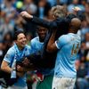 Manchester City's manager Manuel Pellegrini is lifted by his players as they celebrate winning the English Premier League trophy following their soccer match against West Ham United