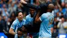 Manchester City's manager Manuel Pellegrini is lifted by his players as they celebrate winning the English Premier League trophy following their soccer match against West