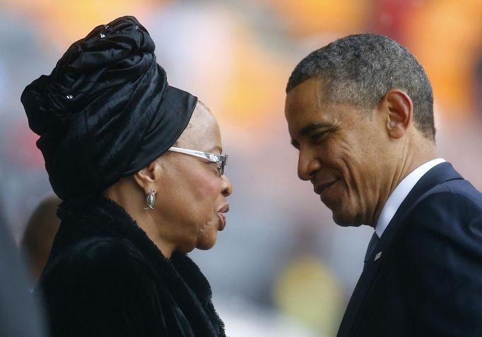 U.S. President Barack Obama pays his respect to Mandela's widow Graca Machel after his speech at the memorial service for late South African President Nelson Mandela at the FNB soccer stadium in Johannesburg December 10, 2013.