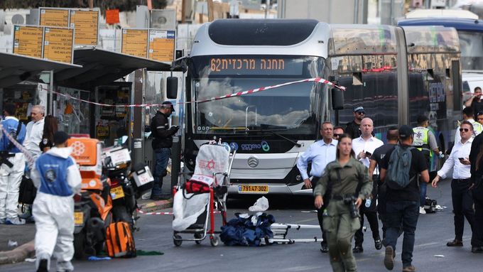 Israeli police officers, forensic experts and emergency personnel work at the scene where a suspected shooting attack took place at the outskirts of Jerusalem September 8