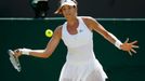 Garbine Muguruza of Spain hits a shot during her match against Angelique Kerber of Germany at the Wimbledon Tennis Championships in London