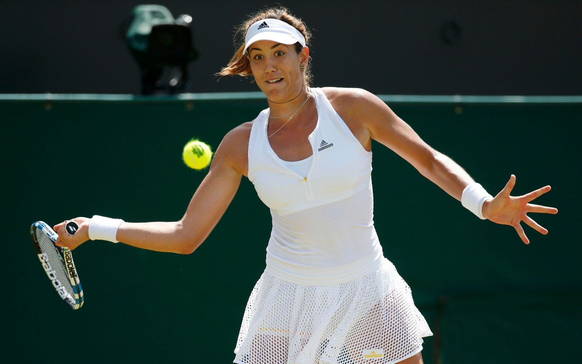 Garbine Muguruza of Spain hits a shot during her match against Angelique Kerber of Germany at the Wimbledon Tennis Championships in London
