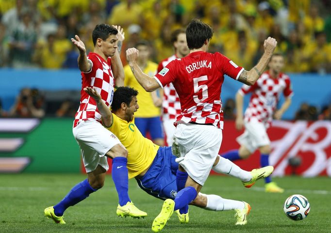 Brazil's Fred (C) is fouled by Croatia's Dejan Lovren (L) during the 2014 World Cup opening match between Brazil and Croatia at the Corinthians arena in Sao Paulo June 12