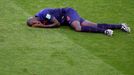 Bruno Martins Indi of the Netherlands lies injured on the pitch after being fouled by Australia's Tim Cahill during their 2014 World Cup Group B soccer match at the Beira