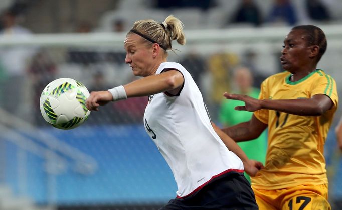 Alexandra Popp (GER) of Germany and Kudakwashe Bhasopo (ZIM) of Zimbabwe in action.