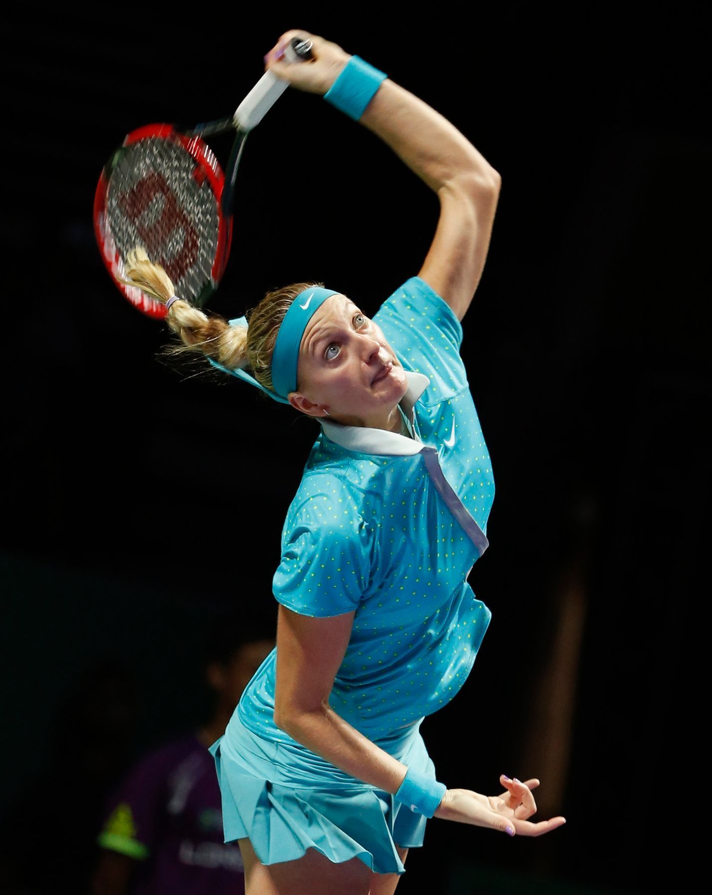 Petra Kvitova of the Czech Republic serves against Maria Sharapova of Russia during their WTA Finals singles tennis match at the Singapore Indoor Stadium