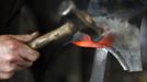 Blacksmith Georg Schmidberger works on a harness for the Vatican Swiss Guard at his workshop in Molln, Upper Austria June 12, 2012. Blacksmith brothers Johann, 29, and Georg, 28, produce made-to-order handmade harnesses for the Vatican, which take 120 hours of handiwork per piece and hardly differs from the 500-year-old originals. The brothers carry on the tradition of the blacksmith trade in the fifth generation of their family. REUTERS/Lisi Niesner (AUSTRIA - Tags: SOCIETY MILITARY) Published: Čer. 12, 2012, 10:18 odp.