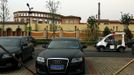 A security guard drives a small vehicle through a carpark outside the surrounding walls of the Florentia Village in the district of Wuqing, located on the outskirts of the city of Tianjin June 13, 2012. The shopping center, which covers an area of some 200,000 square meters, was constructed on a former corn field at an estimated cost of US$220 million and copies old Italian-style architecture with Florentine arcades, a grand canal, bridges, and a building that resembles a Roman Coliseum. REUTERS/David Gray (CHINA - Tags: SOCIETY BUSINESS) Published: Čer. 13, 2012, 5:36 odp.