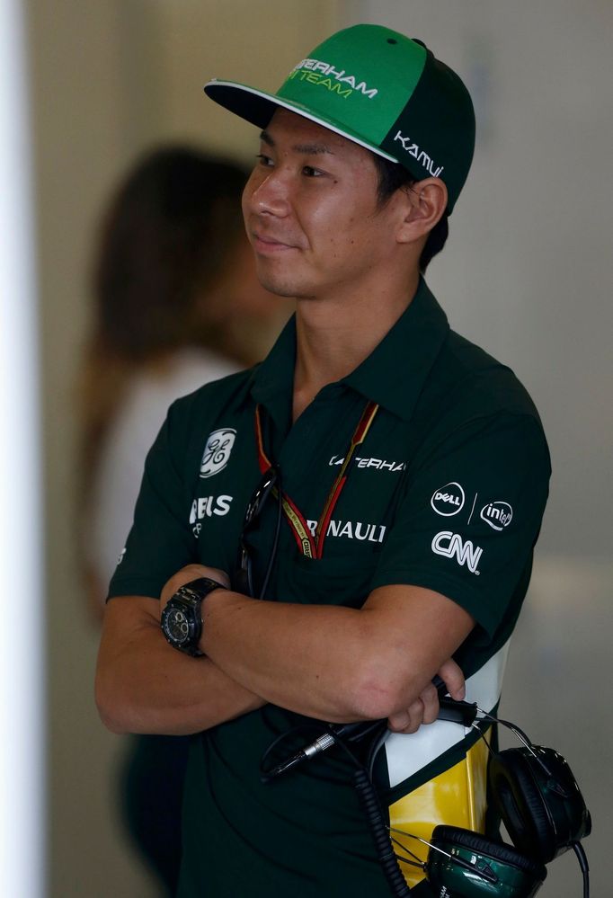 Caterham Formula One driver Kamui Kobayashi of Japan looks on in the garage during the second practice session of the Australian F1 Grand Prix at the Albert Park circuit