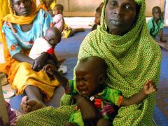 Ženy v uprchlickém táboře Gaga ve východním Čadu čekají, až budou moci nakrmit své podvýživené děti. Dárfúrští lidé často prchali před boji v sousedním Súdánu i přes hranice