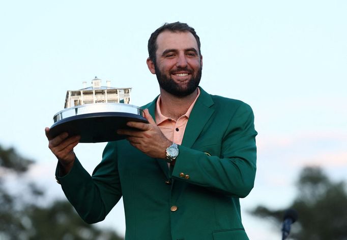 Golf - The Masters - Augusta National Golf Club, Augusta, Georgia, U.S. - April 14, 2024 Scottie Scheffler of the U.S. celebrates with his green jacket and the trophy aft