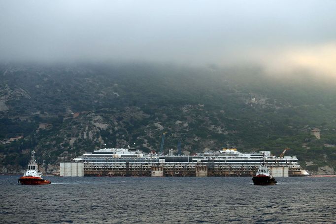 The Costa Concordia cruise liner is pictured from a ferry as it emerges during the refloating operation at Giglio harbour July 20, 2014.