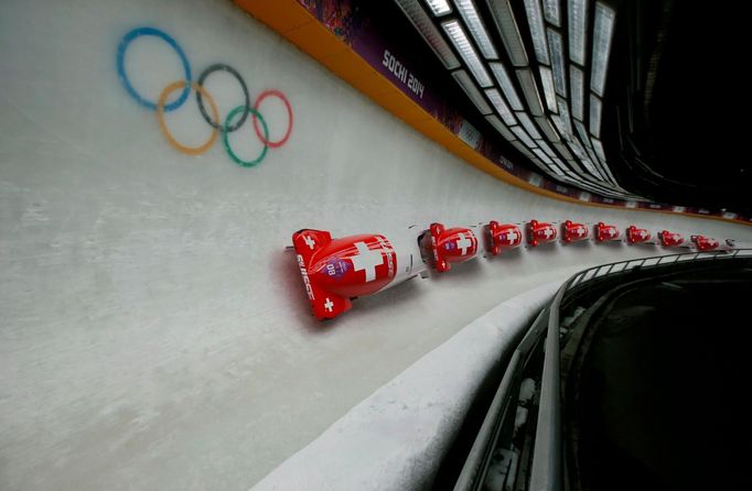 Switzerland's pilot Fabienne Meyer and Tanja Mayer speed down the track during the women's bobsleigh event at the 2014 Sochi Winter Olympics, at the Sanki Sliding Center