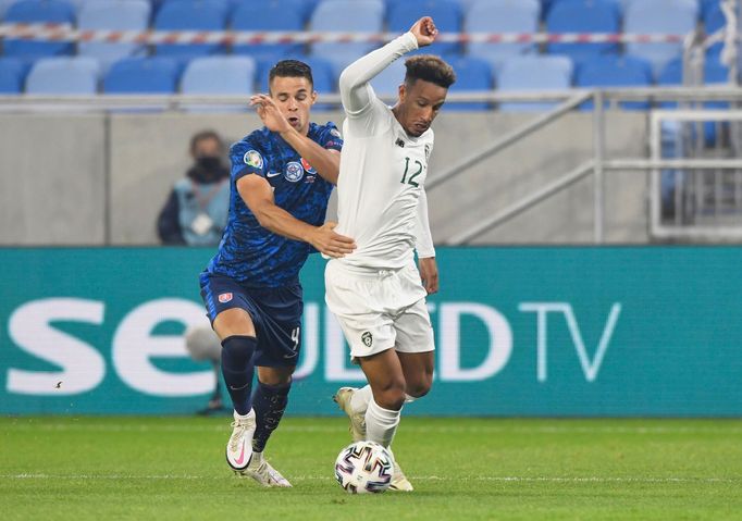 Callum Robinson in action with Slovakia’s Martin Valjent