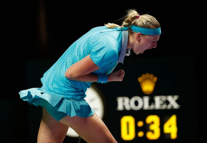 Petra Kvitova of the Czech Republic celebrates winning the first set against Maria Sharapova of Russia during their WTA Finals singles tennis match at the Singapore Indoo