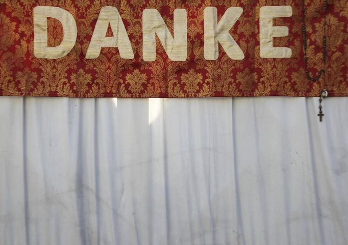 A sign reading "Thank you" in German is seen in St Peter's Square as Pope Benedict XVI holds his last general audience at the Vatican February 27, 2013. The weekly event which would normally be held in a vast auditorium in winter, but has been moved outdoors to St. Peter's Square so more people can attend. The pope has two days left before he takes the historic step of becoming the first pontiff in some six centuries to step down instead of ruling for life. REUTERS/Alessandro Bianchi (VATICAN - Tags: RELIGION) Published: Úno. 27, 2013, 10:52 dop.