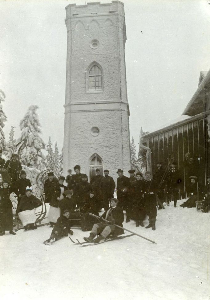 Lyžaři u rozhledny na vrchu Žalý, rok 1898. Dodnes oblíbené místo výletů z nedalekého Benecka a okolí. Ve stavbě rozhledny i restaurace měl opět prsty hrabě Harrach. Před