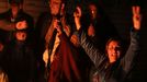 A Kurdish woman holds up a weapon as she celebrates with others in Ras al-Ain, after it was reported that Kurdish forces took control of the Syrian town of Kobani