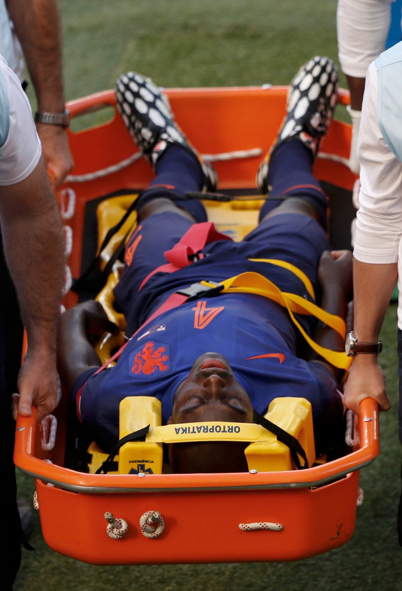 Martins Indi of the Netherlands is carried in a stretcher after being fouled by Australia's Cahill during their 2014 World Cup Group B soccer match at the Beira Rio stadium in Porto Alegre