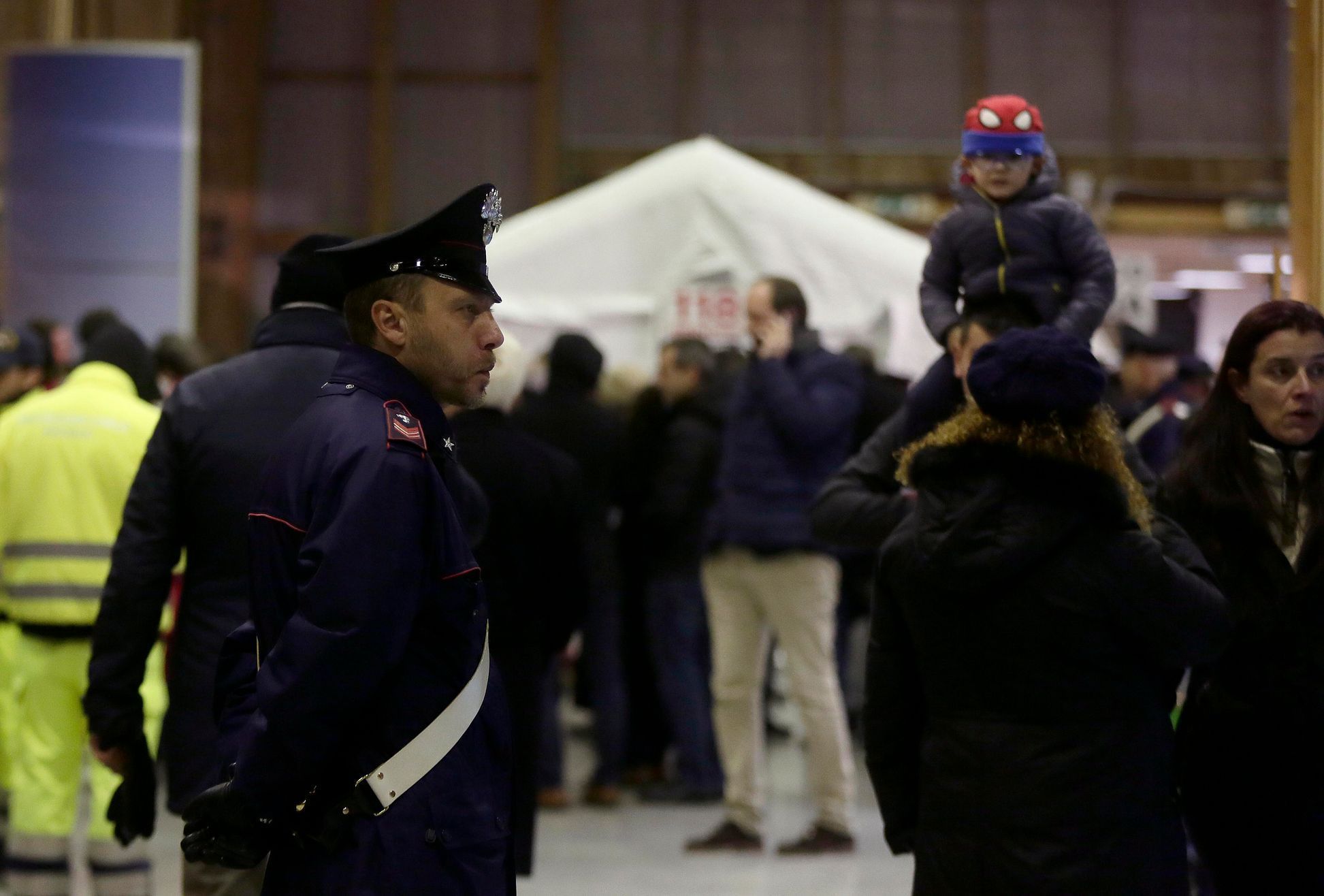 Italian carabiniere stands as relatives of passengers who were rescued after the car ferry Norman Atlantic caught fire off Greece's Adriatic Coast wait for the arrival of the passengers at Brindisi ha