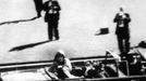 President John F. Kennedy falls over towards Jackie, mortally wounded after he's hit by an assasin's bullet, November 29, 1963, Dallas, Texas