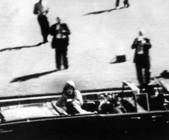 President John F. Kennedy falls over towards Jackie, mortally wounded after he's hit by an assasin's bullet, November 29, 1963, Dallas, Texas