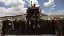 Boys sit on a bulldozer at a garbage disposal site near Sanaa