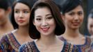 Singapore Airlines stewardesses, who will be appearing at the starting grid, stand together ahead of the Singapore F1 Grand Prix at the Marina Bay street circuit in Singa