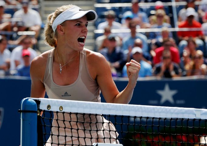 Caroline Wozniacki of Denmark celebrates a point against Maria Sharpova of Russia during their match at the 2014 U.S. Open tennis tournament in New York